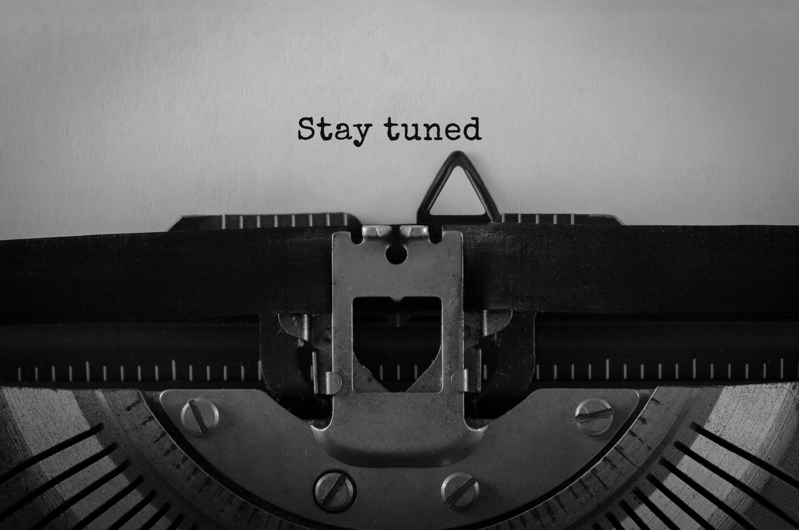 Text Stay Tuned typed on retro typewriter stay tuned